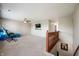 Open loft area with carpeting, fan, and a view of the staircase at 1257 Rosemary Ct, Greenfield, IN 46140