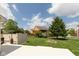 Expansive backyard featuring lush green grass, mature trees, a fire pit, and neighboring houses at 1274 Old Heritage Pl, Greenwood, IN 46143