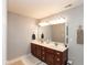 Bathroom with a double sink vanity, dark wood cabinets, a large mirror, and modern lighting at 1274 Old Heritage Pl, Greenwood, IN 46143