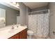 Clean bathroom with a dark wooden vanity, tile floors, and shower with neutral patterned curtain at 1274 Old Heritage Pl, Greenwood, IN 46143