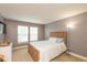 Cozy bedroom with a wooden bed frame, soft lighting, and neutral decor and a TV at 1274 Old Heritage Pl, Greenwood, IN 46143