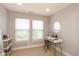 Bright bedroom featuring two windows, neutral walls, and a modern vanity setup with a round mirror at 1274 Old Heritage Pl, Greenwood, IN 46143