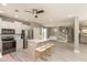 Open kitchen with island seating, stainless appliances, and wood flooring at 1274 Old Heritage Pl, Greenwood, IN 46143