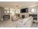 Bright living room with a stone fireplace, a large TV, and comfortable seating, perfect for Gathering gatherings at 1274 Old Heritage Pl, Greenwood, IN 46143