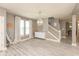 Living room with decorative chandelier, large windows and wooden staircase at 1274 Old Heritage Pl, Greenwood, IN 46143