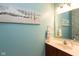 Stylish powder room with a vanity, mirror, and a calming seascape painting, perfect for guests and everyday use at 1274 Old Heritage Pl, Greenwood, IN 46143