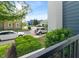 A view from a balcony overlooking a street with well-maintained homes and lush greenery at 12833 Tradd St # 1B, Carmel, IN 46032