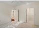 Spacious bedroom with neutral carpet, white walls, and several doorways at 12833 Tradd St # 1B, Carmel, IN 46032