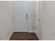A welcoming entryway featuring a white front door and dark wood-look flooring at 12833 Tradd St # 1B, Carmel, IN 46032