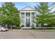 Attractive condo building with large columns and well-maintained landscaping and charming curb appeal at 12833 Tradd St # 1B, Carmel, IN 46032