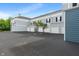 Apartment building exteriors with garages and two young trees at 12833 Tradd St # 1B, Carmel, IN 46032