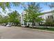 Street view of a condo building, showcasing its architectural details and surrounding greenery at 12833 Tradd St # 1B, Carmel, IN 46032