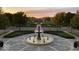 Central community fountain, lush landscaping, and tranquil atmosphere at 12833 Tradd St # 1B, Carmel, IN 46032
