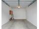 View of a clean, empty garage with painted walls and a concrete floor at 12833 Tradd St # 1B, Carmel, IN 46032