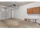 View of a two-car garage with overhead door and an unfinished concrete floor at 12833 Tradd St # 1B, Carmel, IN 46032