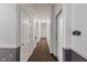 Hallway featuring multiple doors and clean design elements at 12833 Tradd St # 1B, Carmel, IN 46032