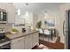 Stylish kitchen with granite countertops, white cabinets, stainless appliances and a dining area at 12833 Tradd St # 1B, Carmel, IN 46032