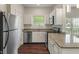 Bright kitchen featuring granite counters, stainless appliances, and white cabinets at 12833 Tradd St # 1B, Carmel, IN 46032