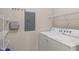 Functional laundry room with washer, dryer, and shelving for organized storage at 12833 Tradd St # 1B, Carmel, IN 46032