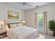 Staged bedroom with a comfortable bed, stylish decor, window with blinds, and ceiling fan at 12833 Tradd St # 1B, Carmel, IN 46032