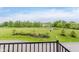 Peaceful backyard view with green space, pond, and blue skies at 12990 Moultrie St, Carmel, IN 46032