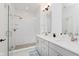 Modern bathroom features a glass-enclosed shower, dual vanity, and elegant fixtures at 12990 Moultrie St, Carmel, IN 46032