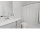 Clean bathroom features a vanity with gray cabinets and shower with curtain at 12990 Moultrie St, Carmel, IN 46032