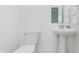 Cozy half bathroom featuring a pedestal sink and simple fixtures in a small space at 12990 Moultrie St, Carmel, IN 46032