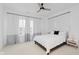 Well-lit bedroom with a ceiling fan, neutral-toned curtains, and a comfortable bed at 12990 Moultrie St, Carmel, IN 46032