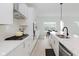 Modern kitchen features sleek white cabinets, stainless steel appliances, and a stylish island at 12990 Moultrie St, Carmel, IN 46032