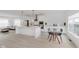 Bright kitchen featuring white cabinets, modern appliances, and an island with a stone countertop at 12990 Moultrie St, Carmel, IN 46032