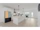 Bright kitchen featuring white cabinets, modern appliances, and an island with a stone countertop at 12990 Moultrie St, Carmel, IN 46032