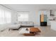 Open-concept living room with a modern kitchen and light wood-style flooring at 12990 Moultrie St, Carmel, IN 46032