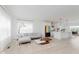 Open-concept living room with a modern kitchen and light wood-style flooring at 12990 Moultrie St, Carmel, IN 46032