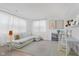 Bright living room with white walls, neutral furniture and light wood style flooring at 12990 Moultrie St, Carmel, IN 46032