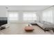 Open-concept living room with a modern kitchen and light wood-style flooring at 12990 Moultrie St, Carmel, IN 46032