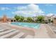 Community pool area with multiple lounge chairs and ample space for relaxation and swimming at 12990 Moultrie St, Carmel, IN 46032