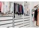 Organized walk-in closet features hanging rods, shelves, and drawers for ample storage at 12990 Moultrie St, Carmel, IN 46032