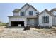 Two-story house featuring a garage, front door, and windows surrounded by construction materials at 1415 Beaumont Cir, Westfield, IN 46074