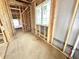 Hallway under construction with exposed wooden beams and a window to the side at 1415 Beaumont Cir, Westfield, IN 46074