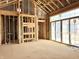 Room under construction with exposed wooden beams and sliding glass doors, offering views and abundant natural light at 1415 Beaumont Cir, Westfield, IN 46074