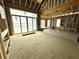 Large living room under construction with a high ceiling, big windows, and sliding doors to the exterior at 1415 Beaumont Cir, Westfield, IN 46074