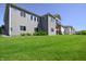 Spacious backyard with lush green grass and a view of the multi-level deck, ideal for outdoor entertaining at 1472 Maple Ridge Ct, Columbus, IN 47201