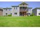 Expansive backyard featuring a well-maintained lawn, a spacious deck, and a two-story house with gray siding at 1472 Maple Ridge Ct, Columbus, IN 47201
