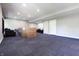 Open basement featuring blue carpeting, offering a versatile space for recreation or storage at 1472 Maple Ridge Ct, Columbus, IN 47201