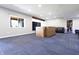 Spacious finished basement with stylish blue carpet, natural light, and ample room for various activities at 1472 Maple Ridge Ct, Columbus, IN 47201