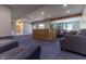 Expansive basement featuring plush blue carpeting and comfortable gray seating, perfect for relaxation and entertainment at 1472 Maple Ridge Ct, Columbus, IN 47201