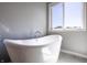 Bathroom featuring a freestanding tub next to a window, offering a serene and bright space at 1472 Maple Ridge Ct, Columbus, IN 47201