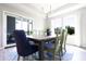Open dining room featuring a wood table, comfortable seating, and sliding door access to the deck at 1472 Maple Ridge Ct, Columbus, IN 47201