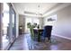 Dining room with natural light, hardwood floors, and modern chandelier at 1472 Maple Ridge Ct, Columbus, IN 47201